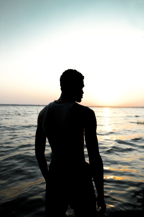 Silhouette of Athletic Adult Man at Sea