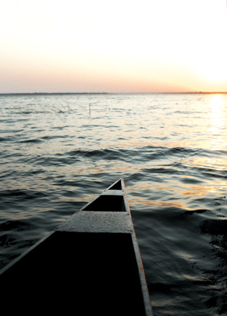 Boat In Water On Sunset