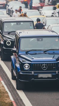 Luxury cars stuck in city traffic, highlighting urban congestion and transport challenges.
