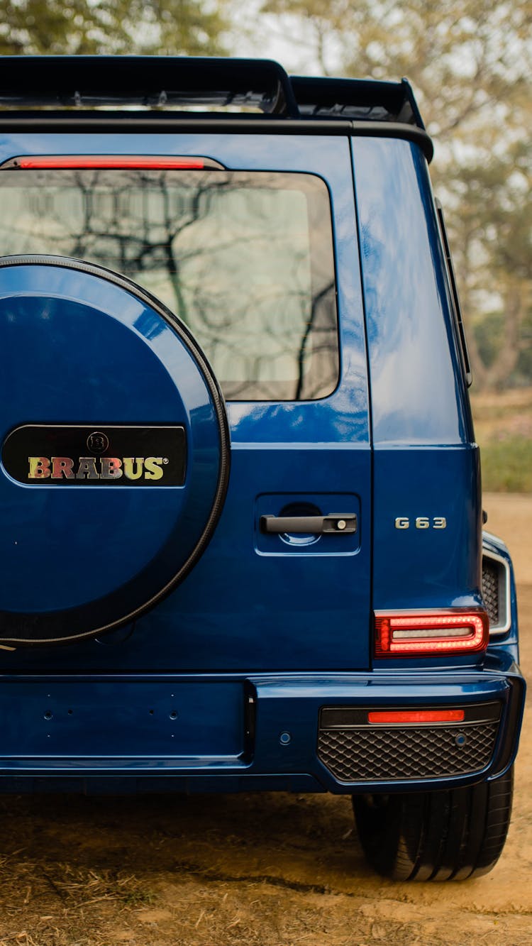 A Blue Jeep In A Forest