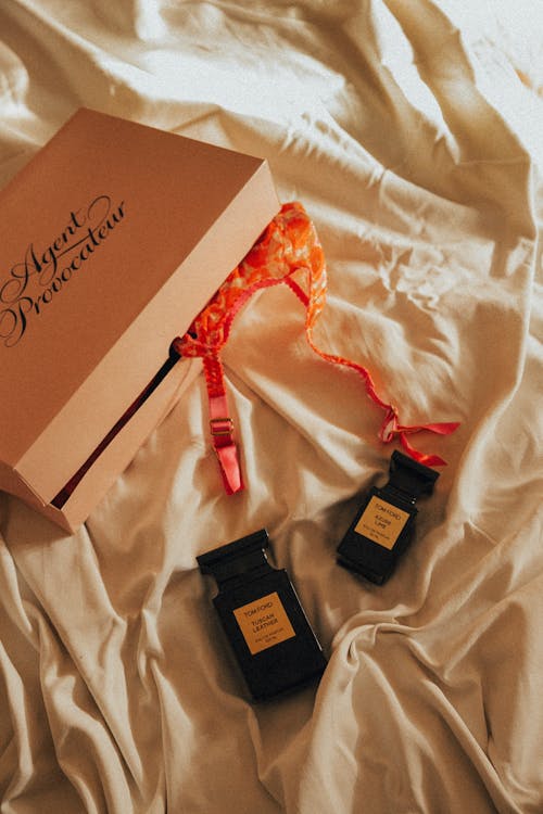Free Close-Up Shot of Black Perfume Bottles beside a Gift Box Stock Photo