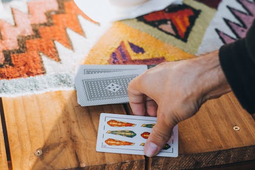 Close-Up Shot of a Person Holding Playing Cards