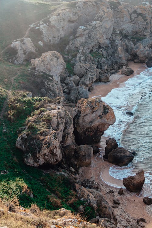 Brown Rock Formation Near Body of Water