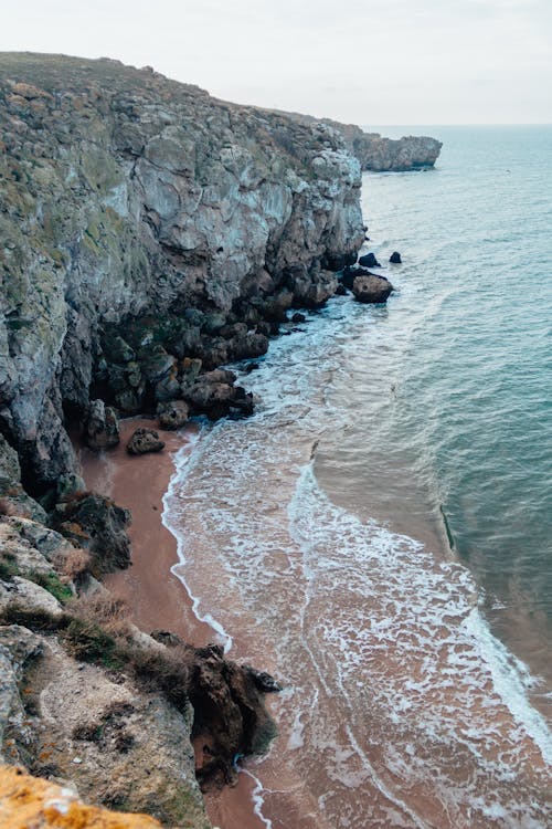 Photos gratuites de bord de mer, formations de pierres, plage