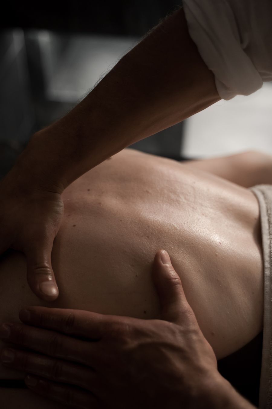 Close-up of a massage therapist performing a therapeutic back massage