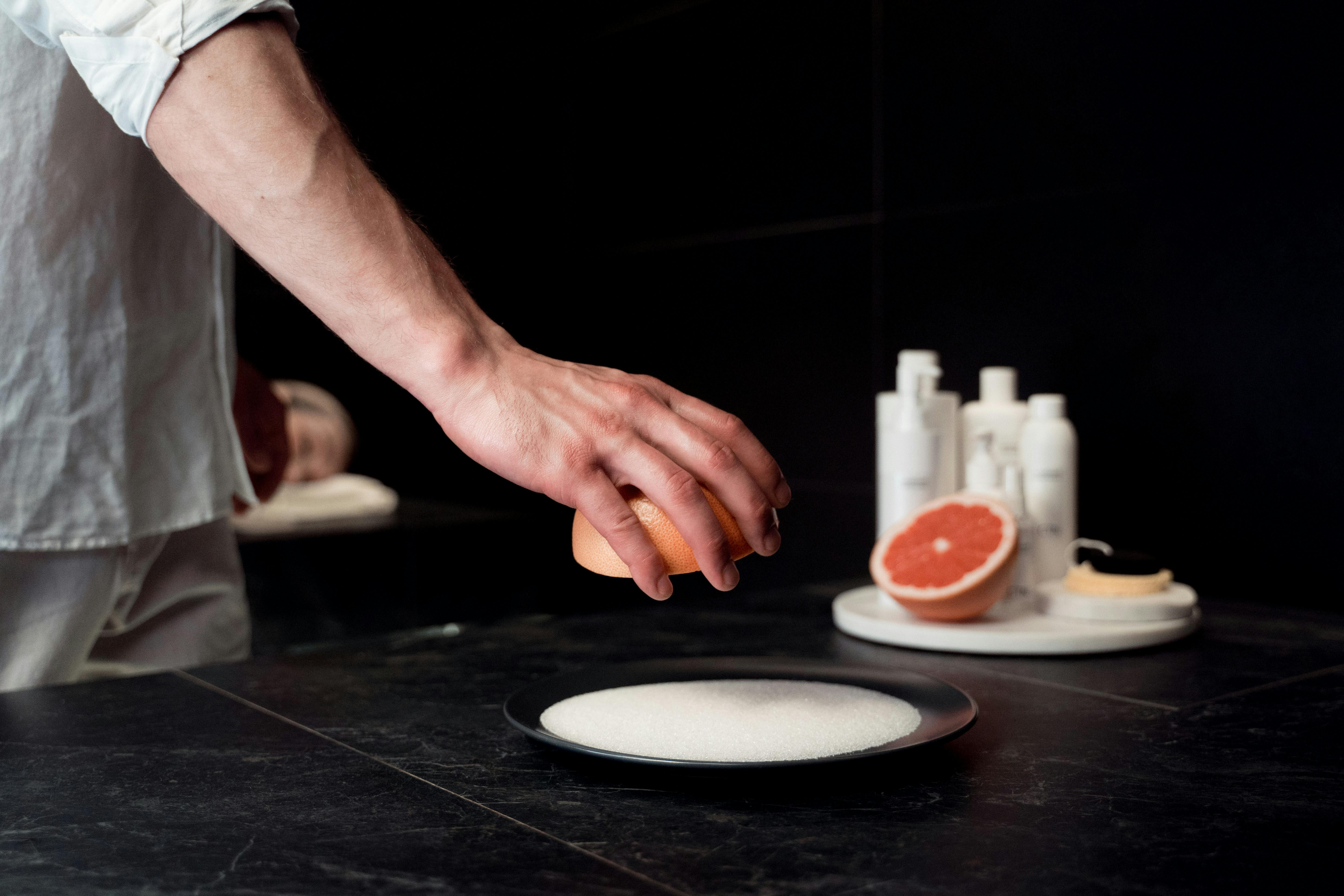 Person Holding a Grapefruit · Free Stock Photo