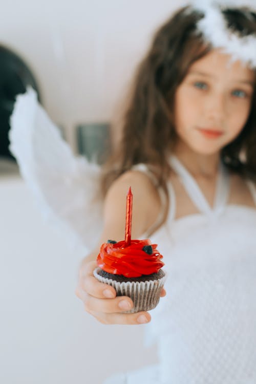 Close-Up Shot of a Girl Holding a Cupcake