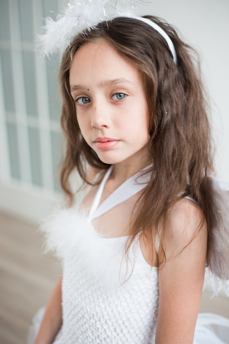 Young Brunette Girl In A Costume Of An Angel