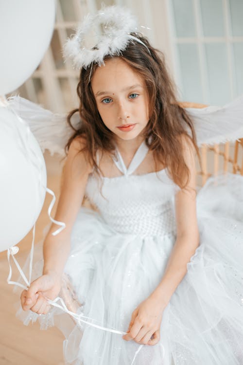 Free Girl in White Dress Holding a Balloons Stock Photo