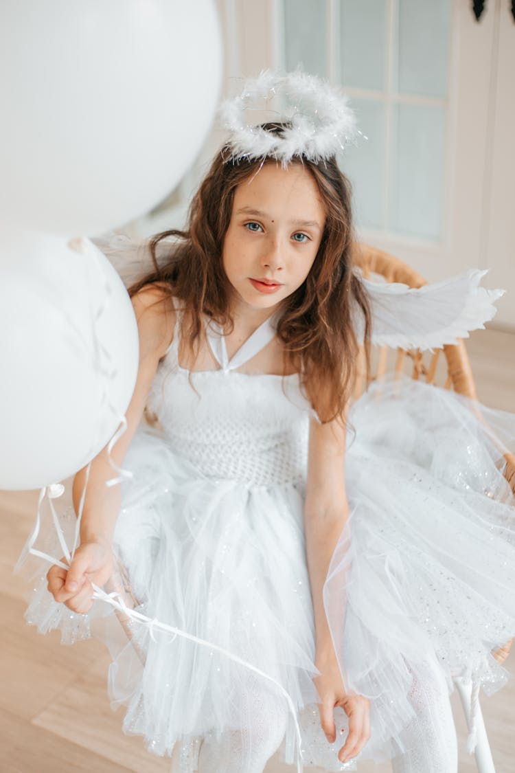 Girl Holding White Balloons