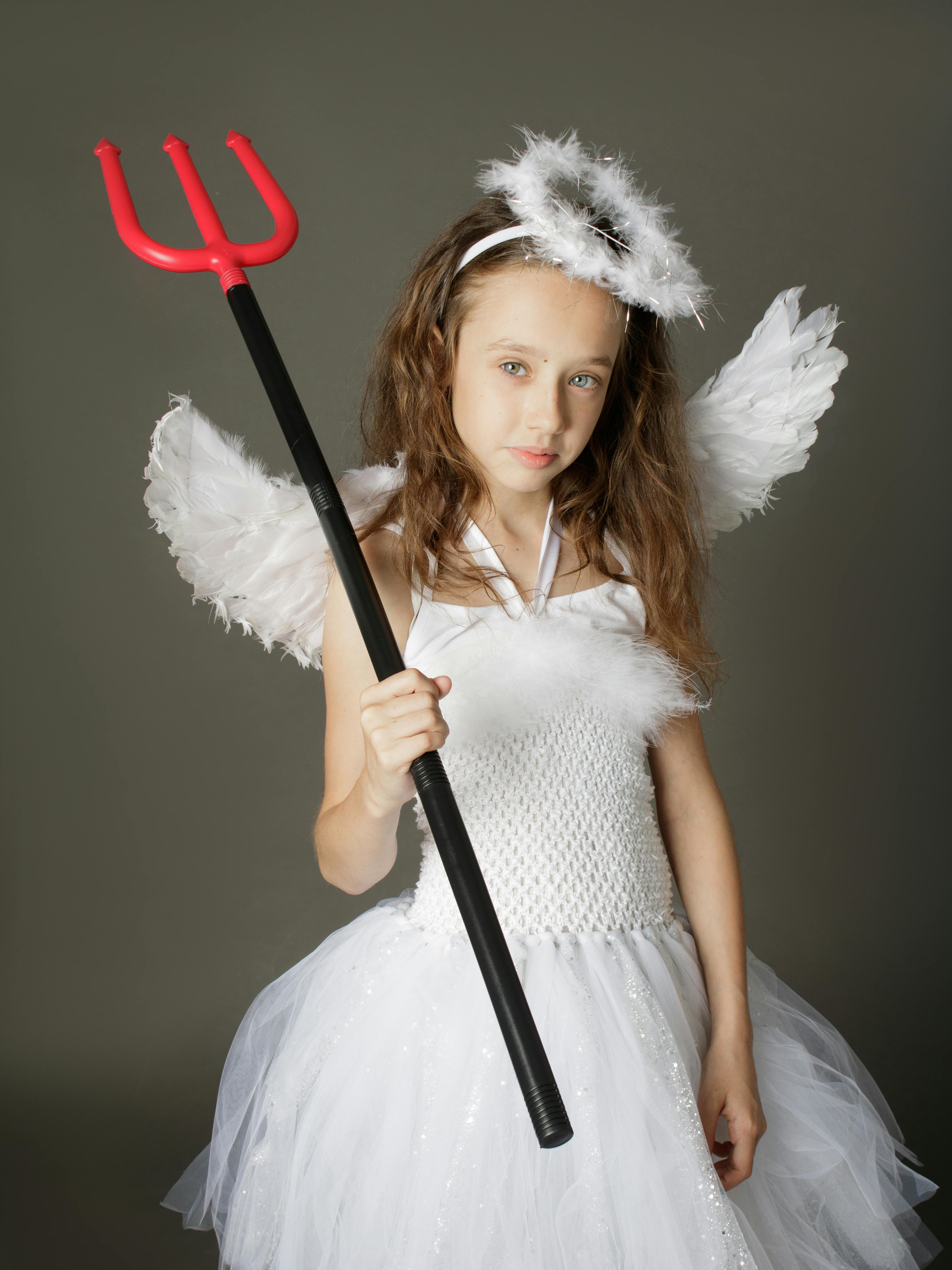 Cute Girl in Angel Costume Holding a Trident · Free Stock Photo
