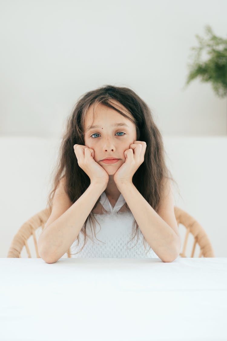 A Cute Girl Leaning On A Table