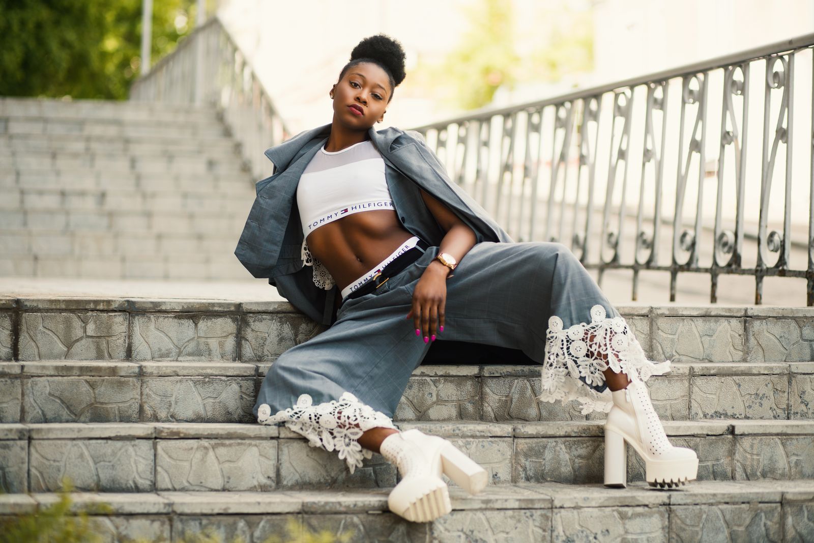 Fashionable woman posing on city steps