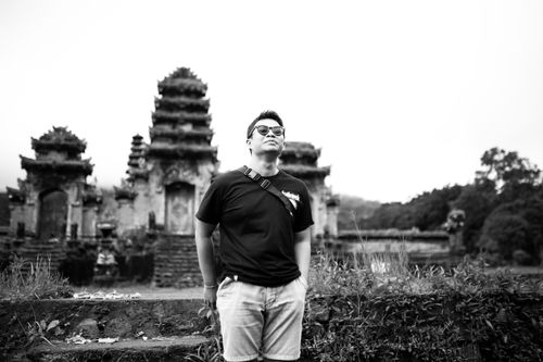 Free Stylish man in black shirt with sunglasses at an ancient temple ruin. Stock Photo