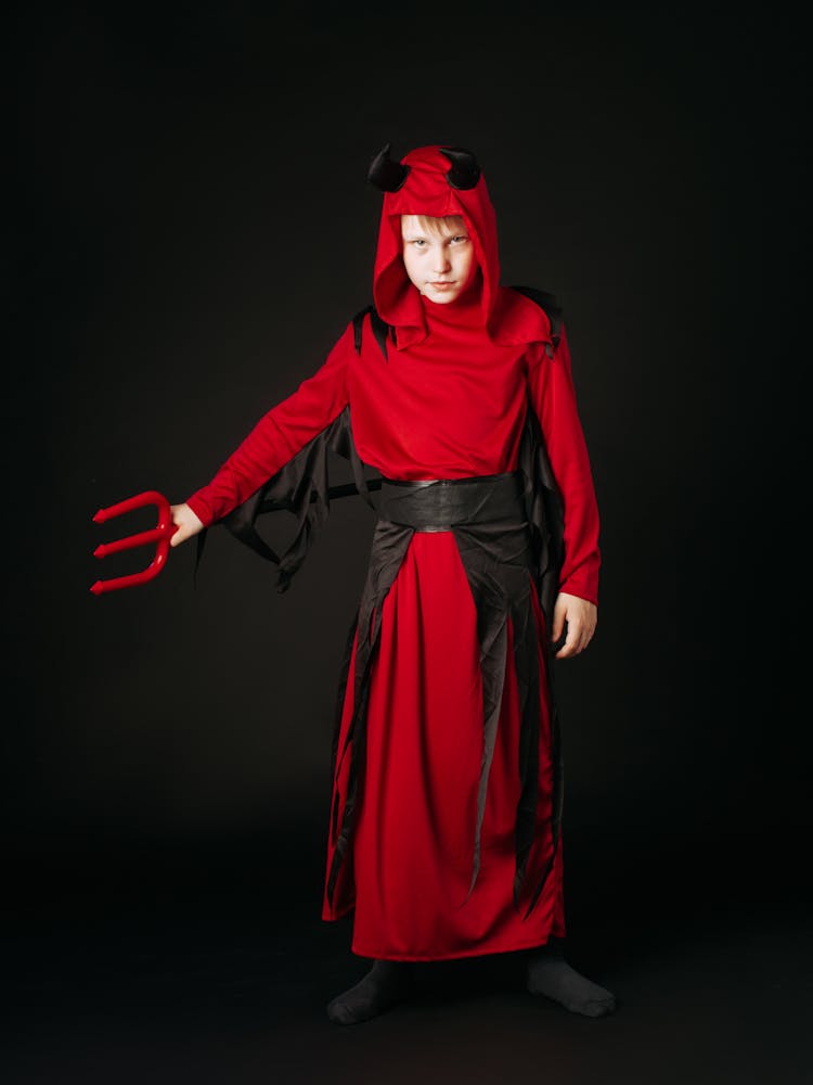 Boy In Devil Costume Holding A Trident