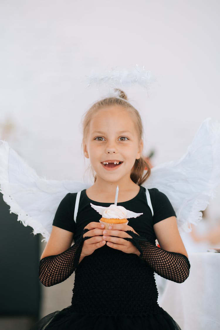 Cute Girl In Holding A Cupcake