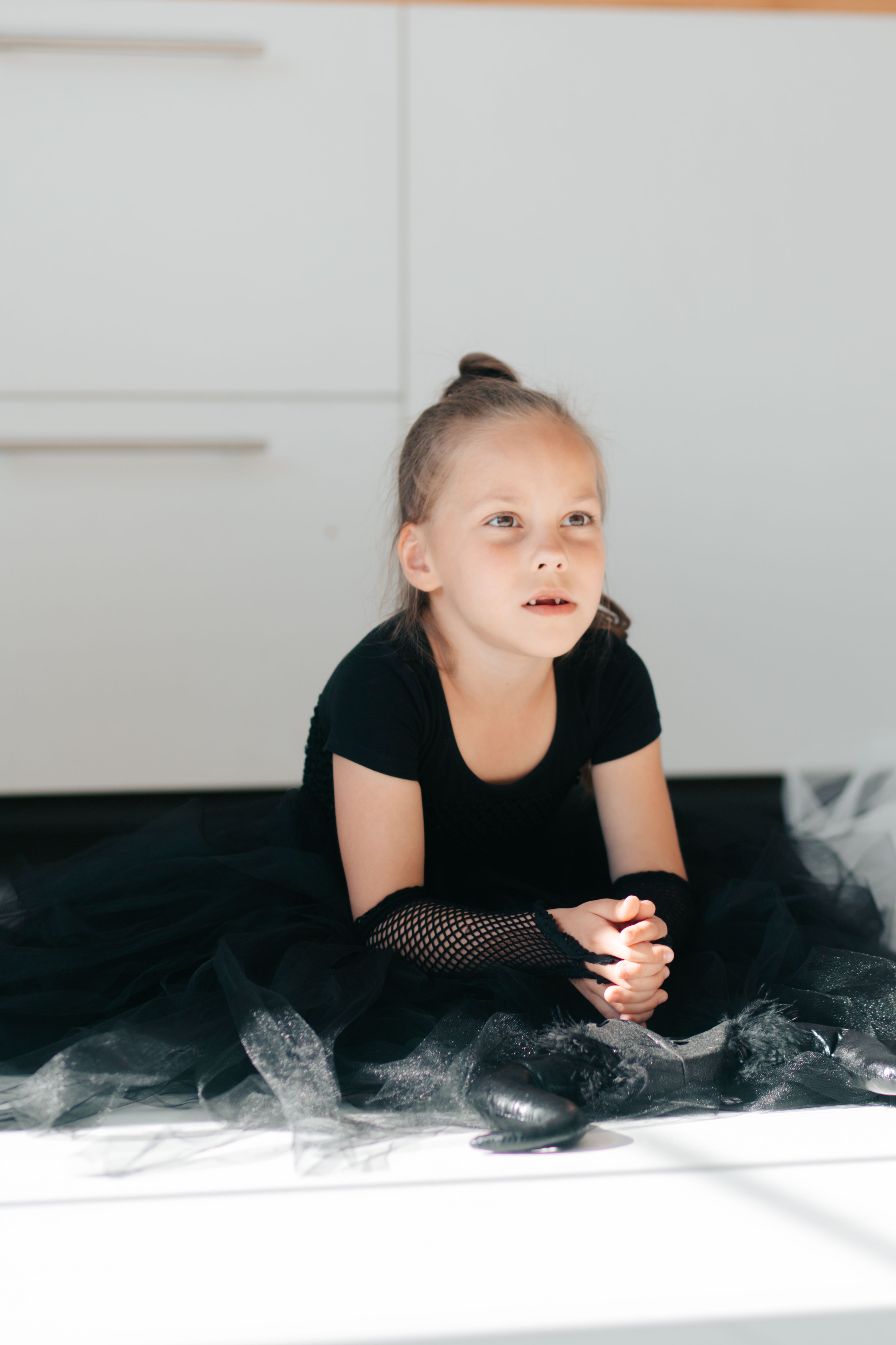 A Girl in Black Dress Sitting on the Floor · Free Stock Photo