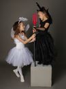 Two Girls in Halloween Costume Holding a Trident