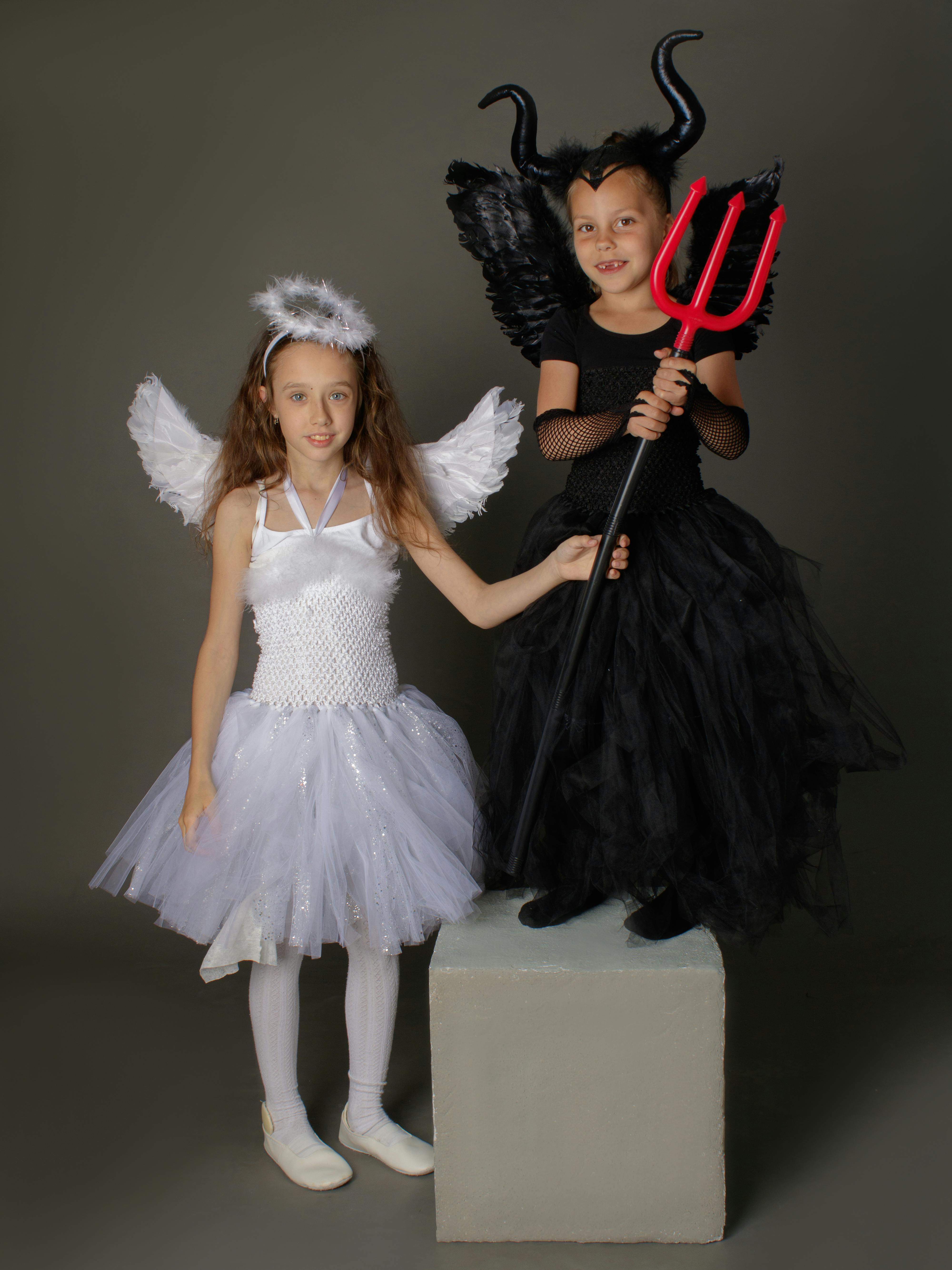 two girls in halloween costume holding a trident