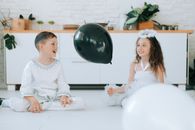 Woman in White Long Sleeve Dress Sitting Beside Man in White Dress Shirt