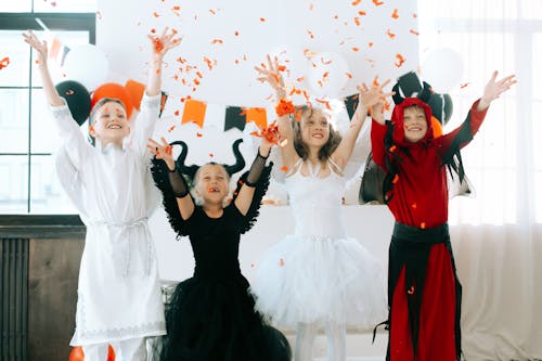 Free Children in Halloween Costumes Having Fun Celebrating the Party Stock Photo