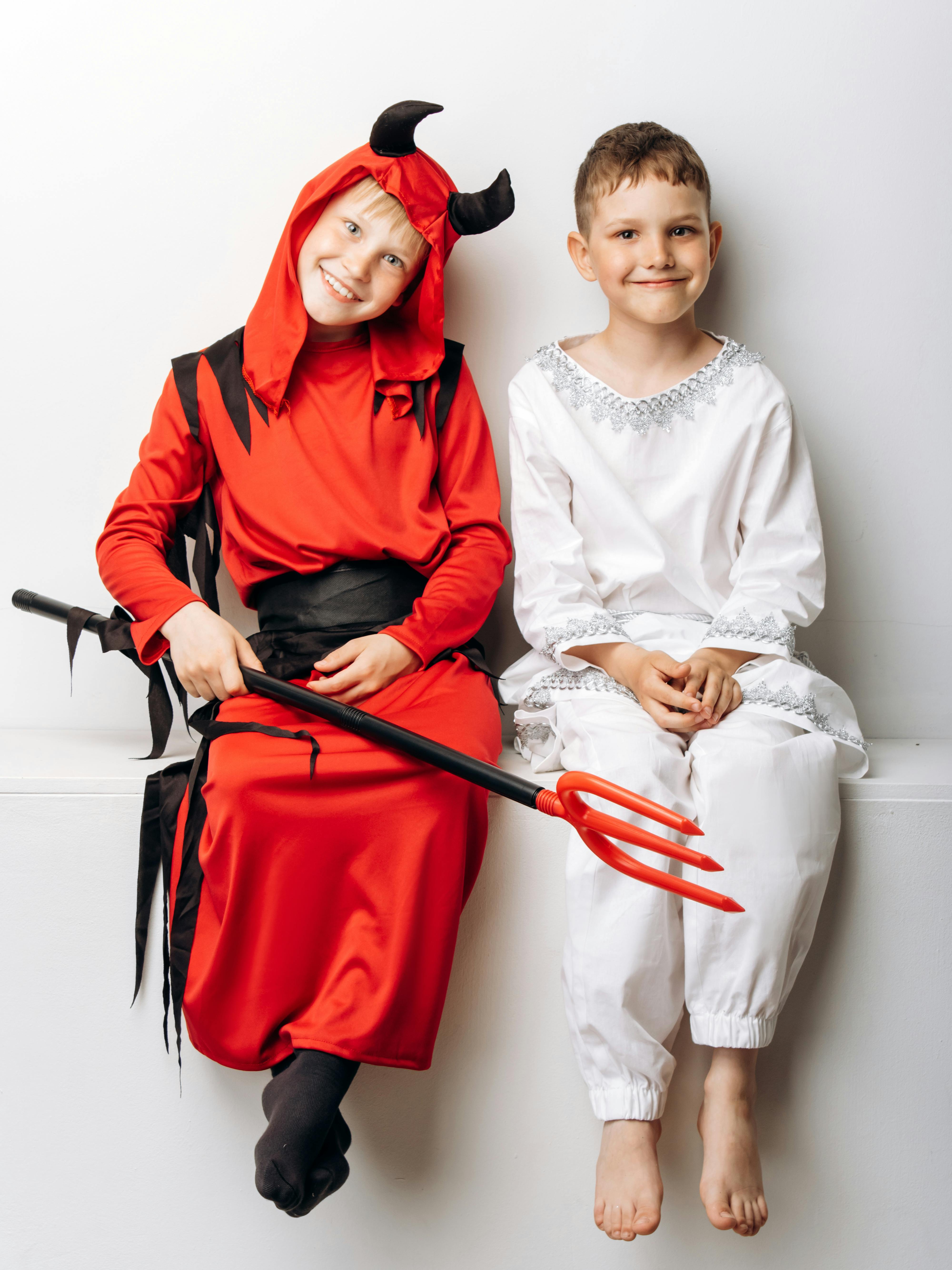 boys in halloween costumes smiling at the camera