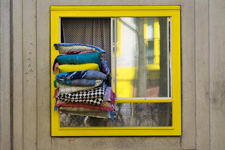 Pillows In Window Of House