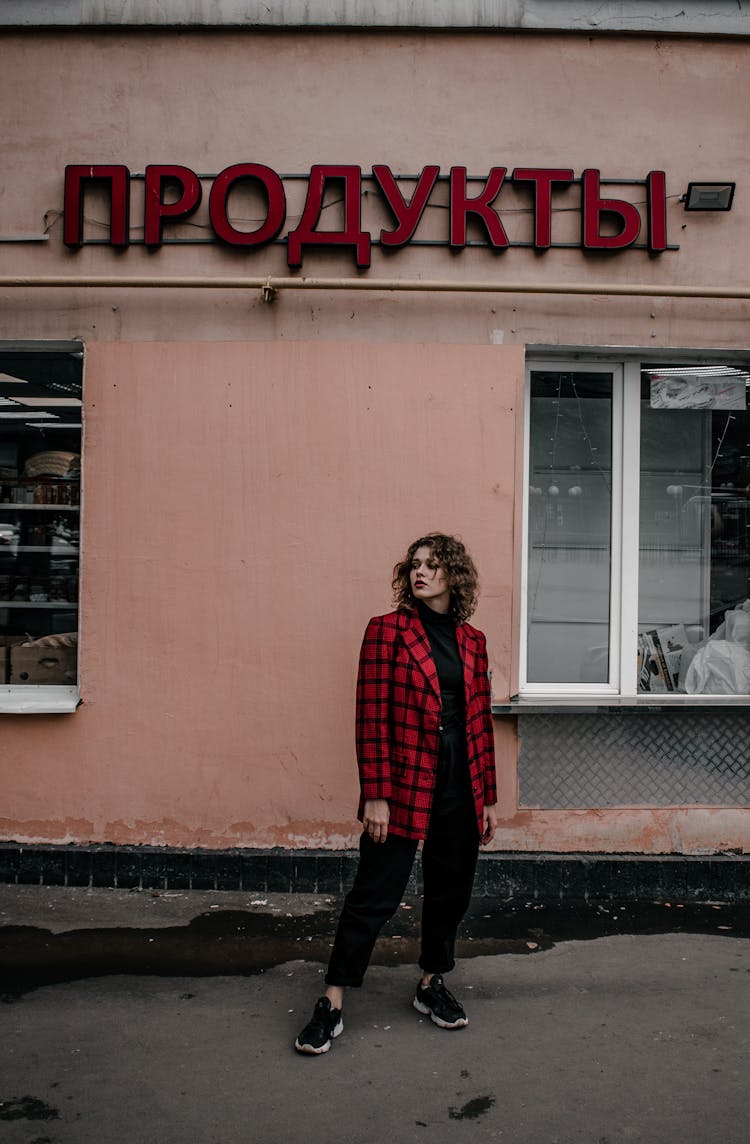 Woman Posing Near Old City Shop