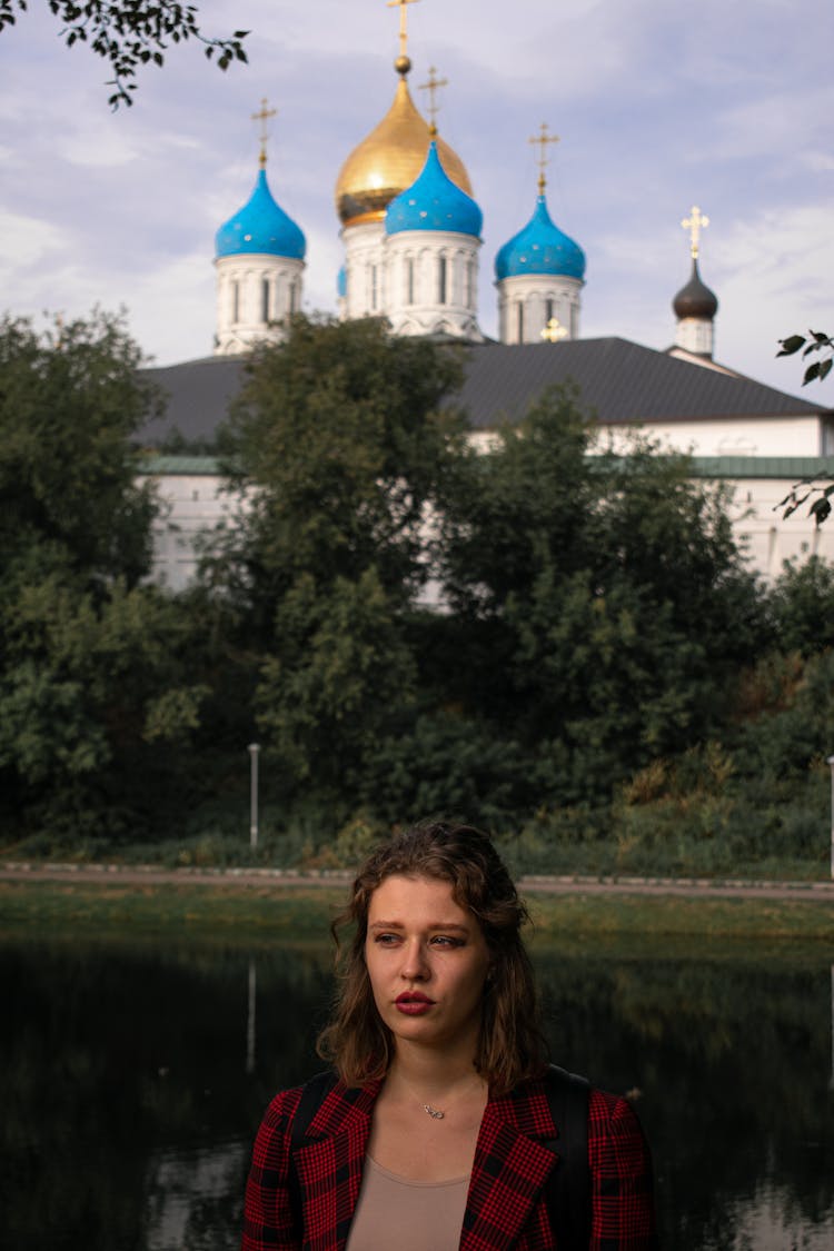 Woman Posing With Church In Background