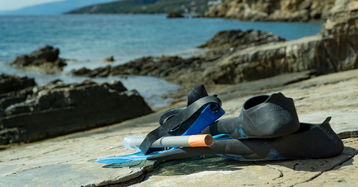 Snorkeling gear on a rocky seaside, perfect for adventures and exploring nature.