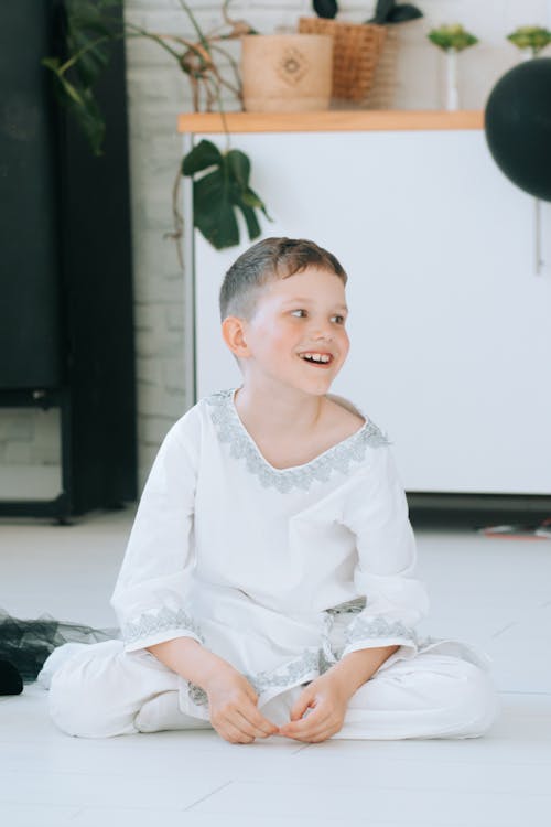 Free A Boy in Angel Costume Sitting on the Floor Stock Photo