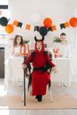 Woman in Black Long Sleeve Dress Holding Red Balloon