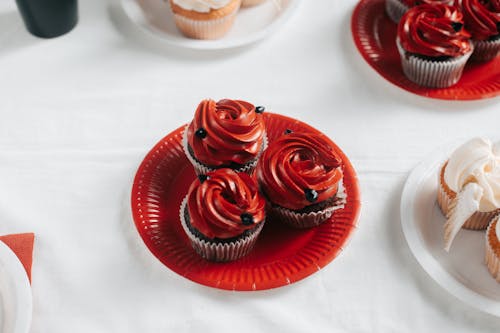 Free Red Icing Chocolate Cupcakes on Red Paper Plate Stock Photo