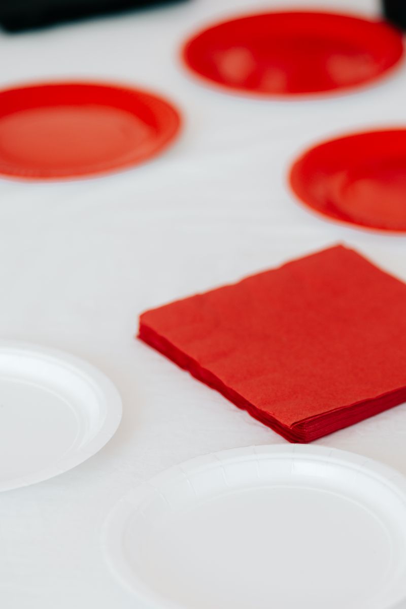 Halloween paper plates and napkins arranged on a party table