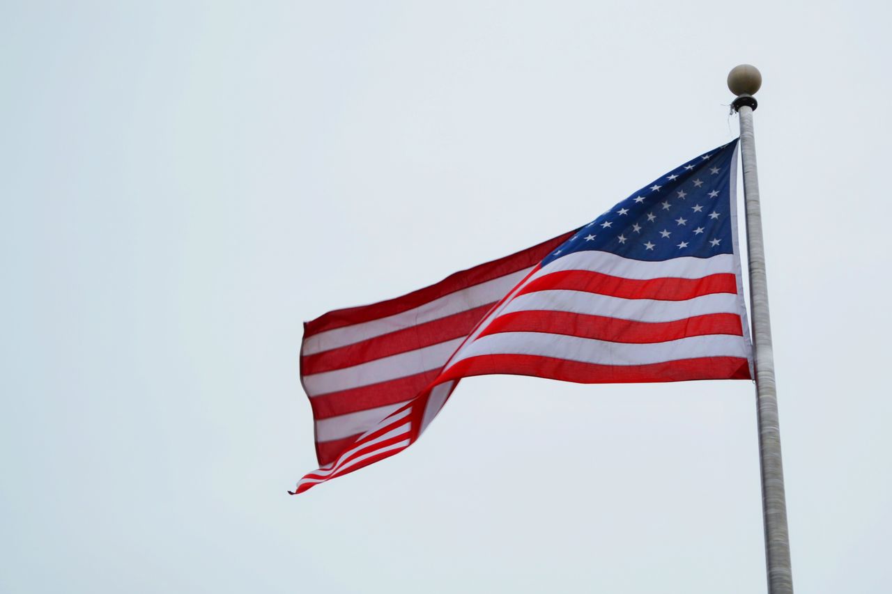 usa flag on pole with clear sky symbolizing freedom and patriotism