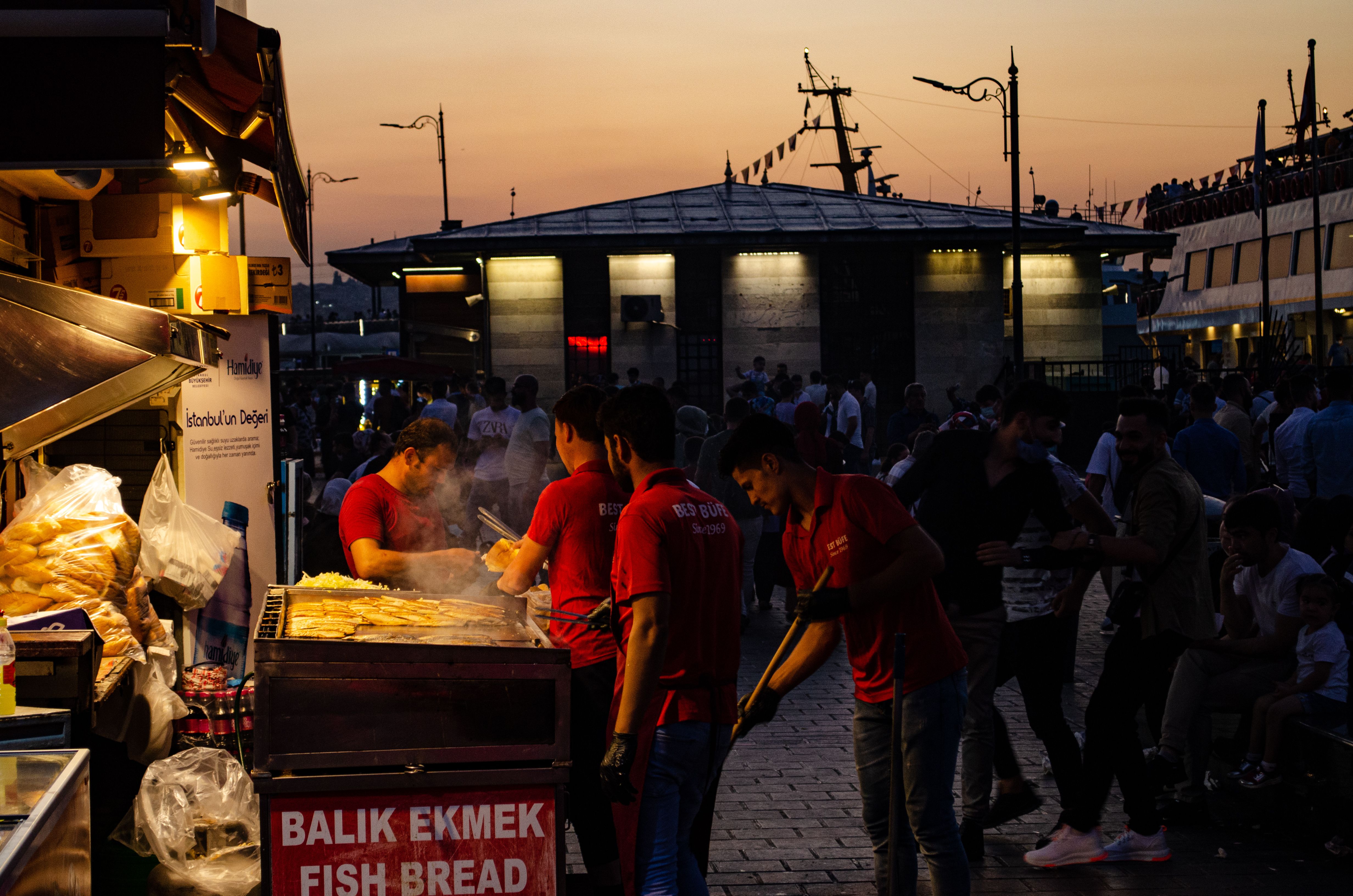 Captivating evening scene of street food vendors grilling Balik Ekmek by the Bosphorus in Istanbul. Captivating evening scene of street food vendors grilling Balik Ekmek by the Bosphorus in Istanbul.