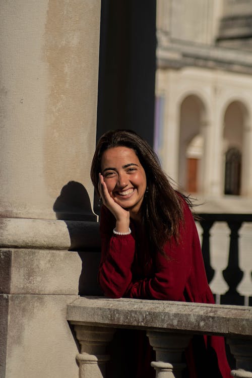 A Woman in Red Long Sleeves Smiling