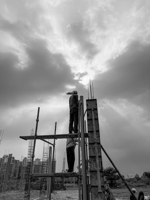 Free Men Building A Concrete Post Stock Photo