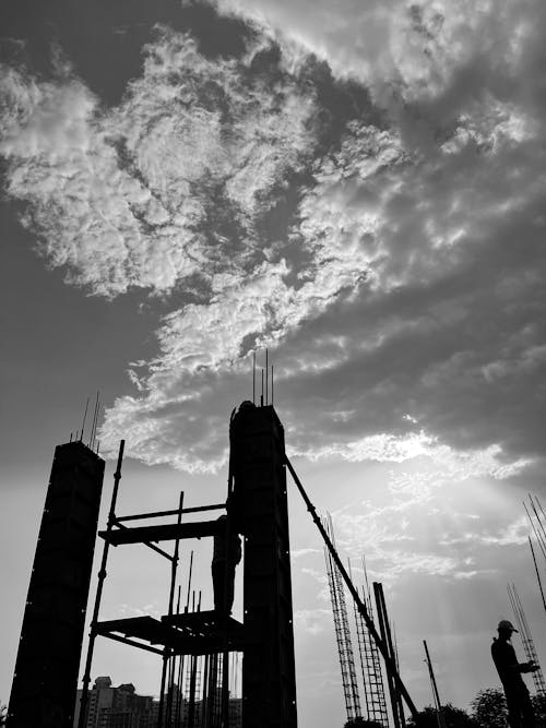 Grayscale Photo of Men Working in a Building