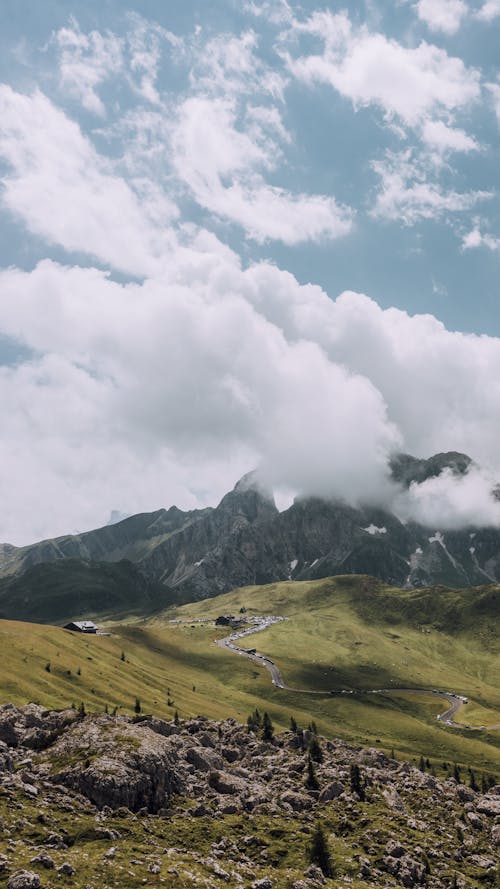 Green Rocky Mountain Under White Clouds