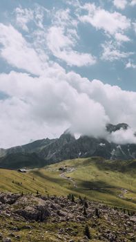 Breathtaking mountain landscape in Veneto, Italy, with clouds and rocky terrain.