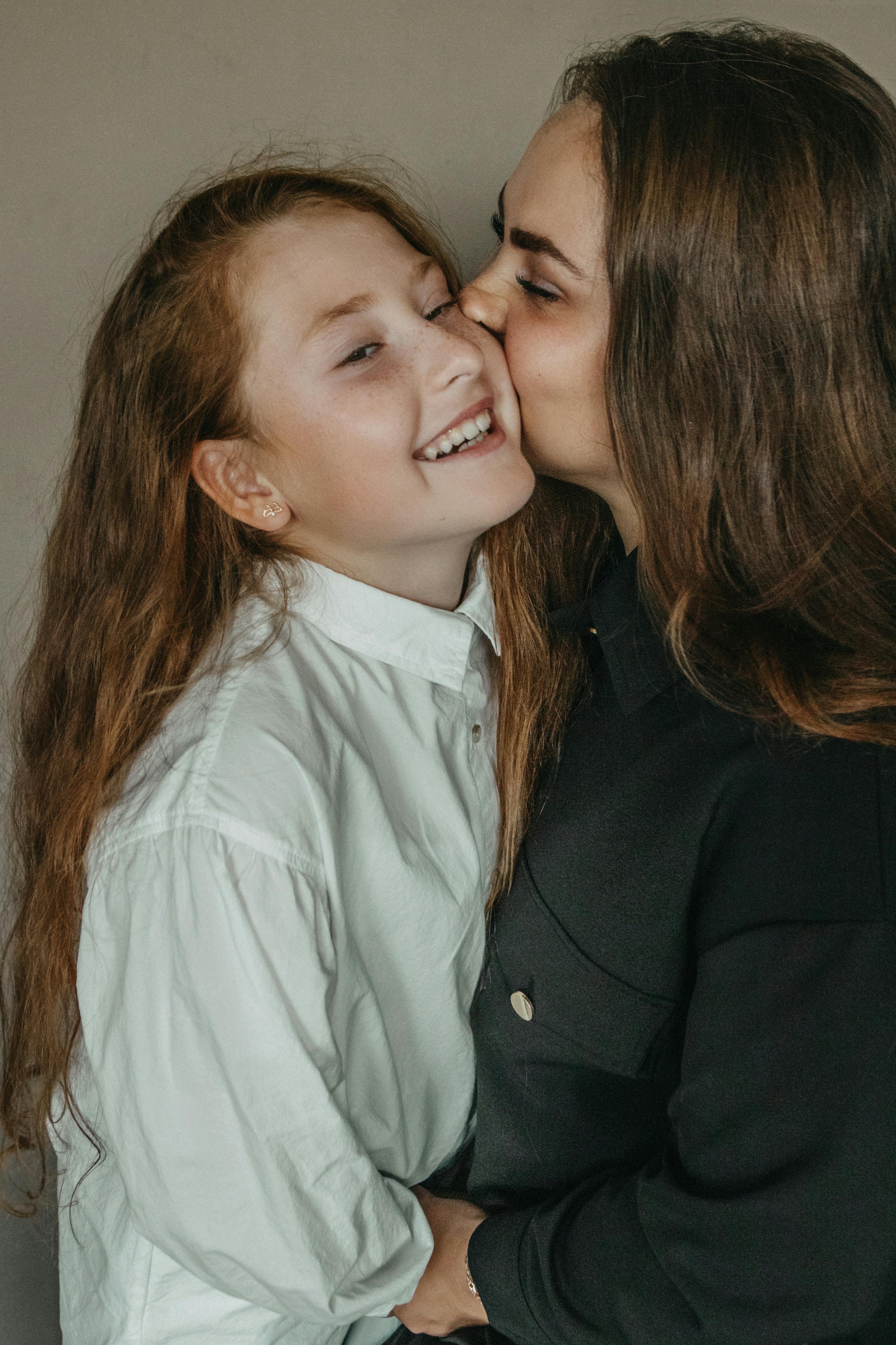 Mom Kissing Her Daughter · Free Stock Photo