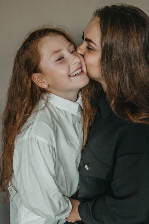 Free Mom Kissing Her Daughter Stock Photo