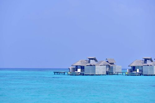 Free Serene overwater bungalows on turquoise waters in the Maldives. Stock Photo