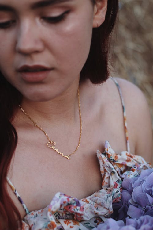 Woman Wearing a Gold Necklace