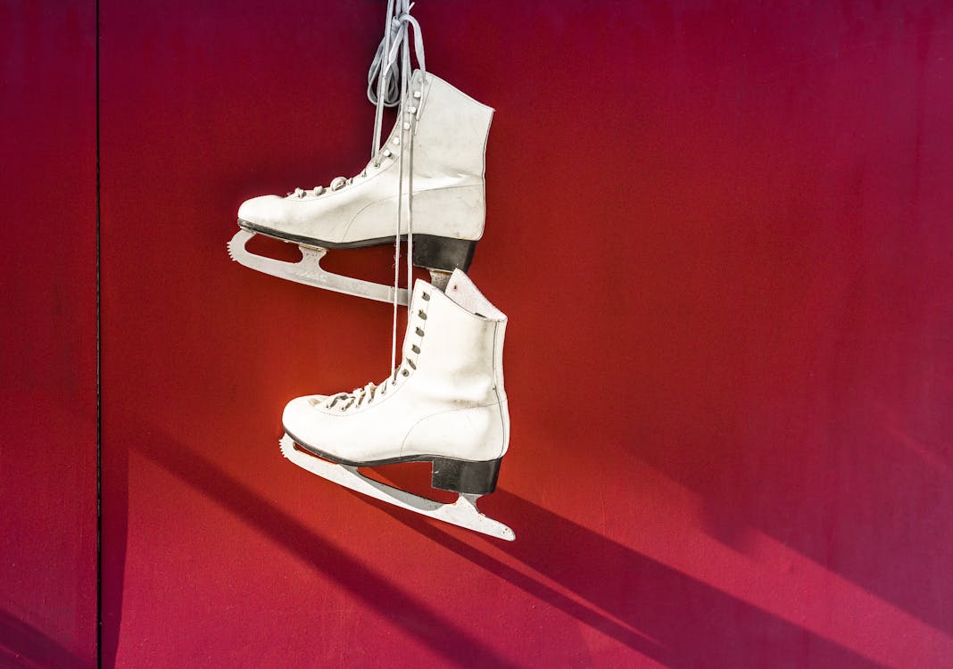 Free Hanged Pair of White Leather Figure Skates Stock Photo