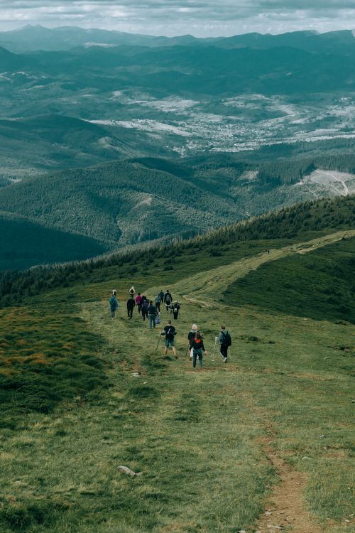 Free A group of hikers enjoy a scenic mountain trail with panoramic views. Stock Photo