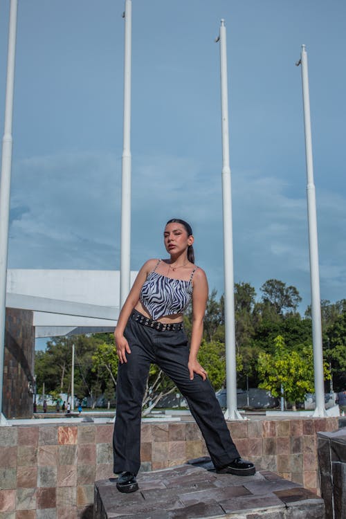 
A Woman Wearing a Crop Top and Black Pants