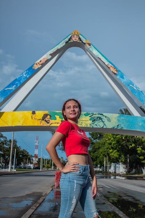 
A Woman Wearing a Crop Top and Denim Pants