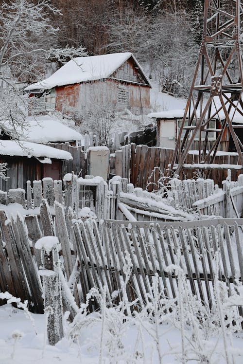 Free 
Snow Covered Houses and Wooden Fences Stock Photo